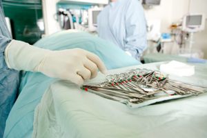 Surgical instruments laid out on a table in an operating room.